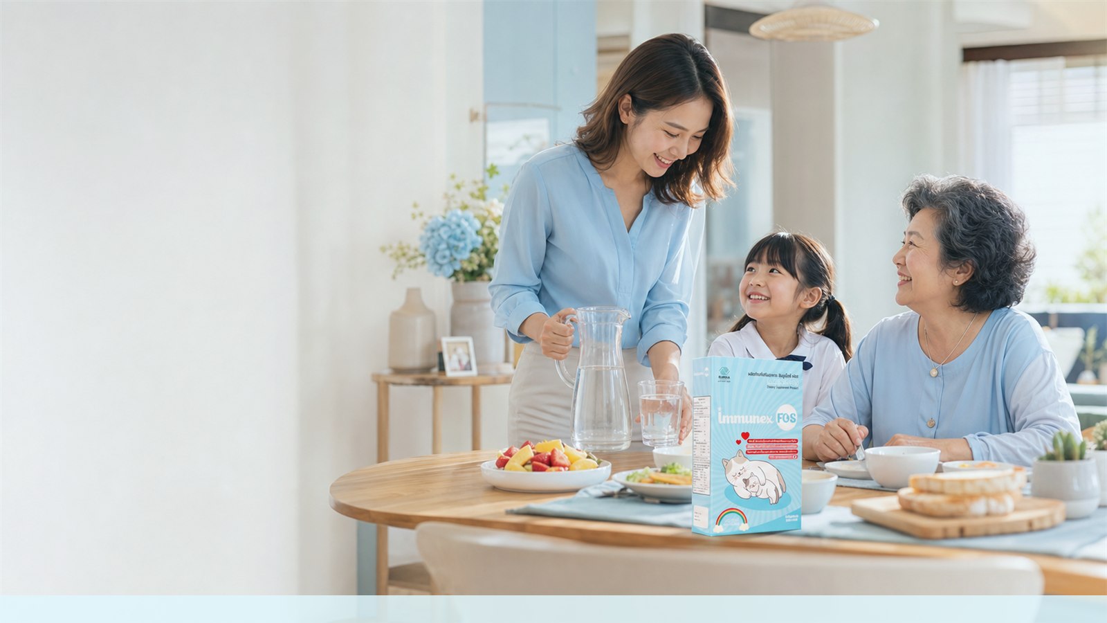 Thai multigenerational family at breakfast with water, fruit, and an IMMUNEX FOS package