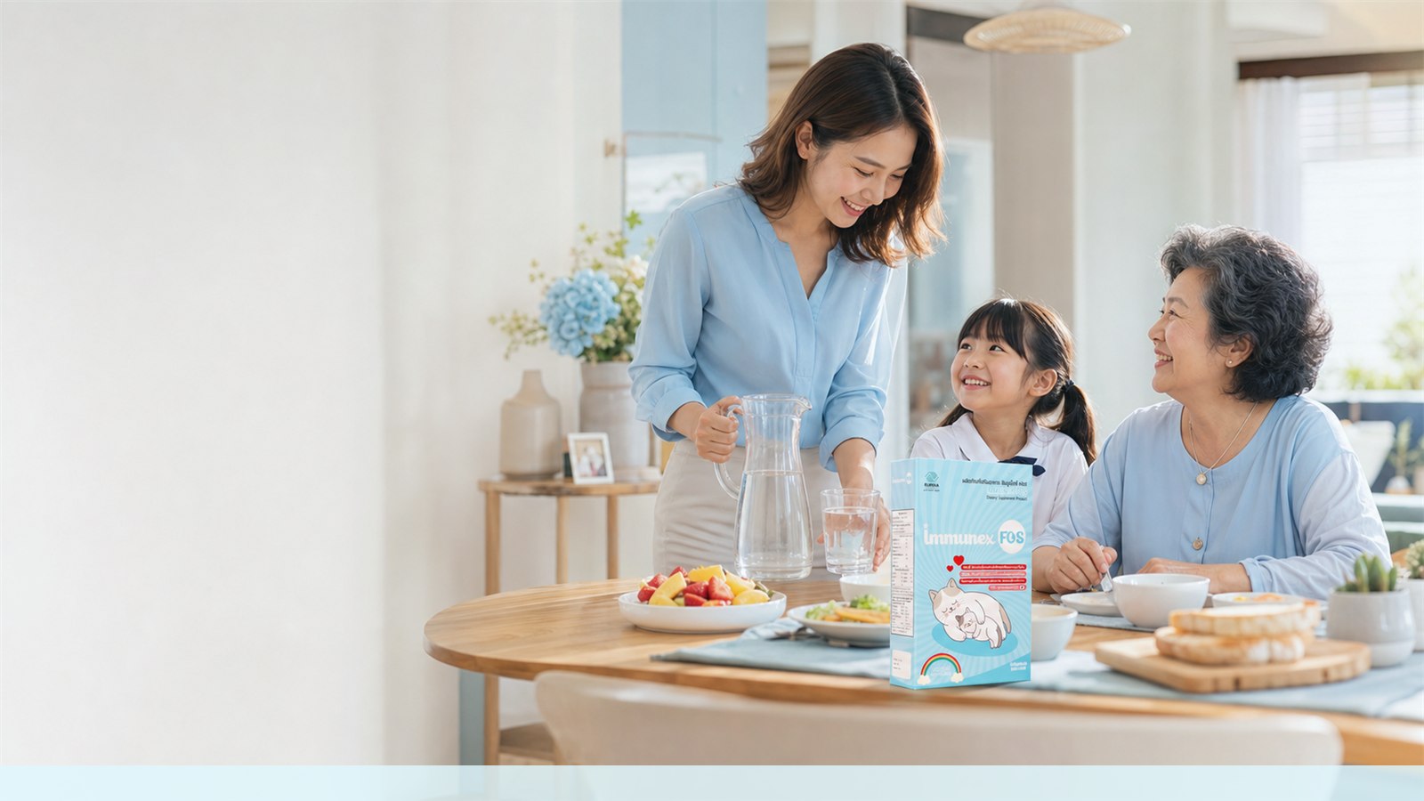 Thai multigenerational family at breakfast with water, fruit, and an IMMUNEX FOS package